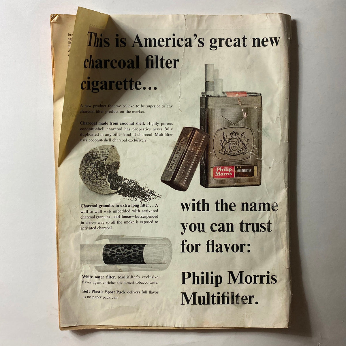 Vintage advertisement for Philip Morris Multifilter cigarettes, showcasing charcoal filter technology. Featured in the vintage issue of VTG Time Magazine July 3 1964.