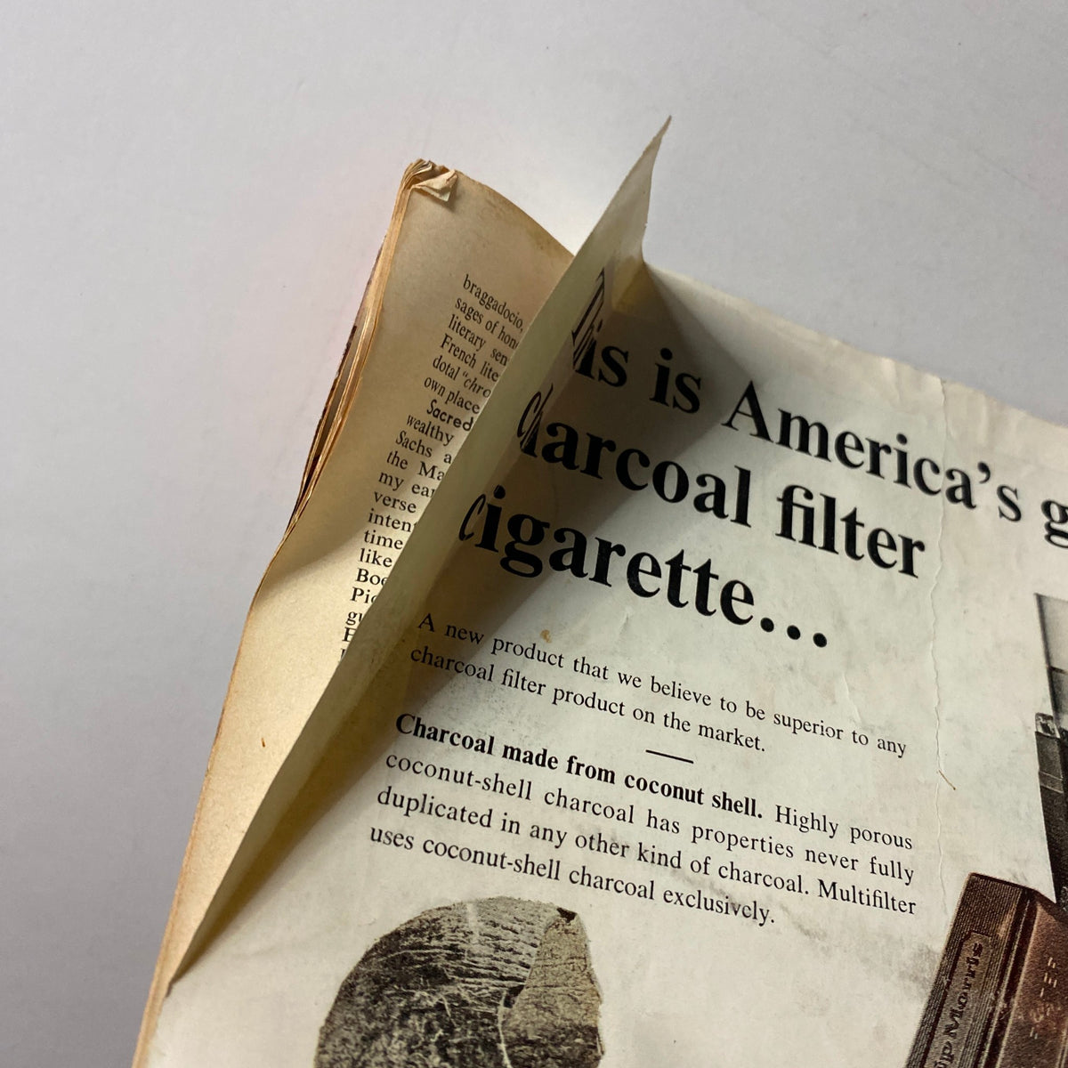 Close-up view of a vintage advertisement for Philip Morris Multifilter cigarettes, detailing the benefits of charcoal filter technology. From the vintage VTG Time Magazine July 3 1964.