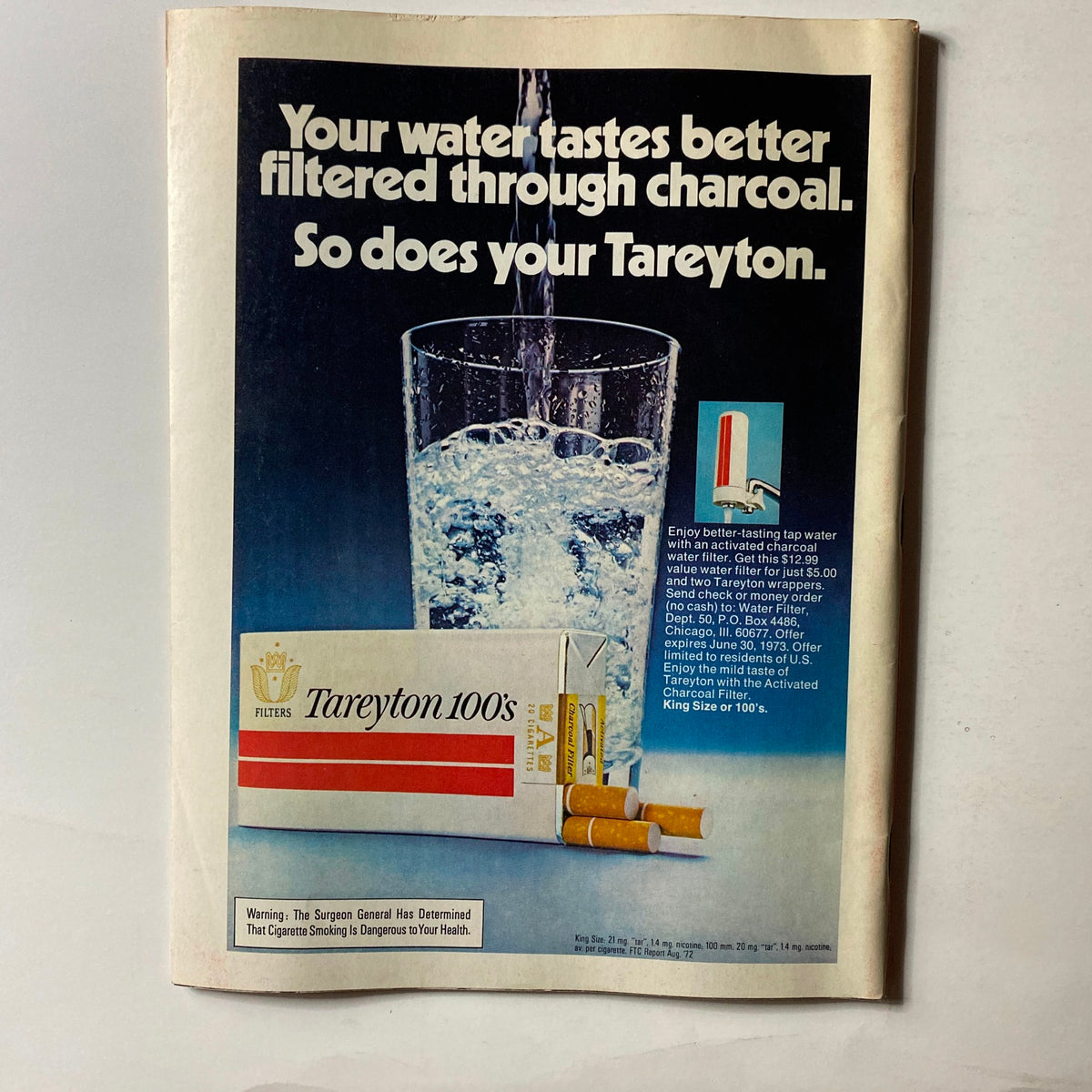 Back cover of a vintage magazine advertisement for Tareyton 100's cigarettes, promoting water filters with a glass filled with water.