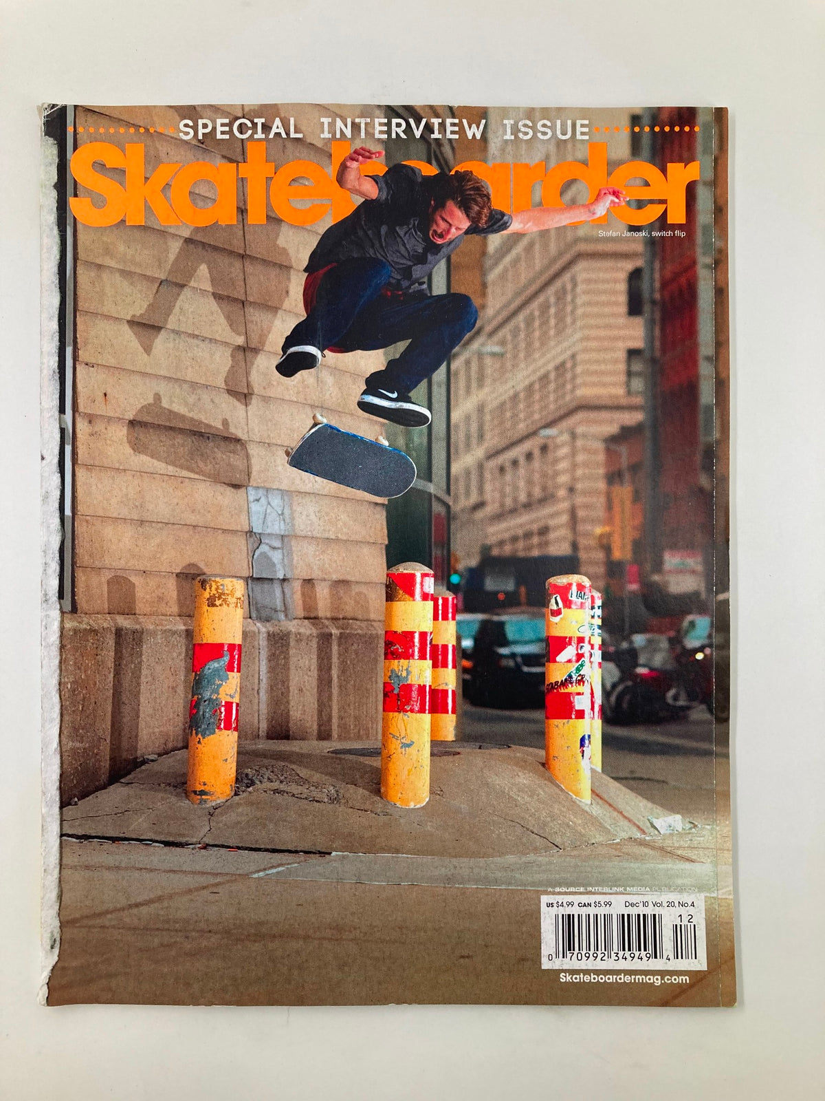 Cover of Skateboarder Magazine December 2010, featuring Stefan Janoski performing a Switch Flip, showcasing vibrant urban skate culture.