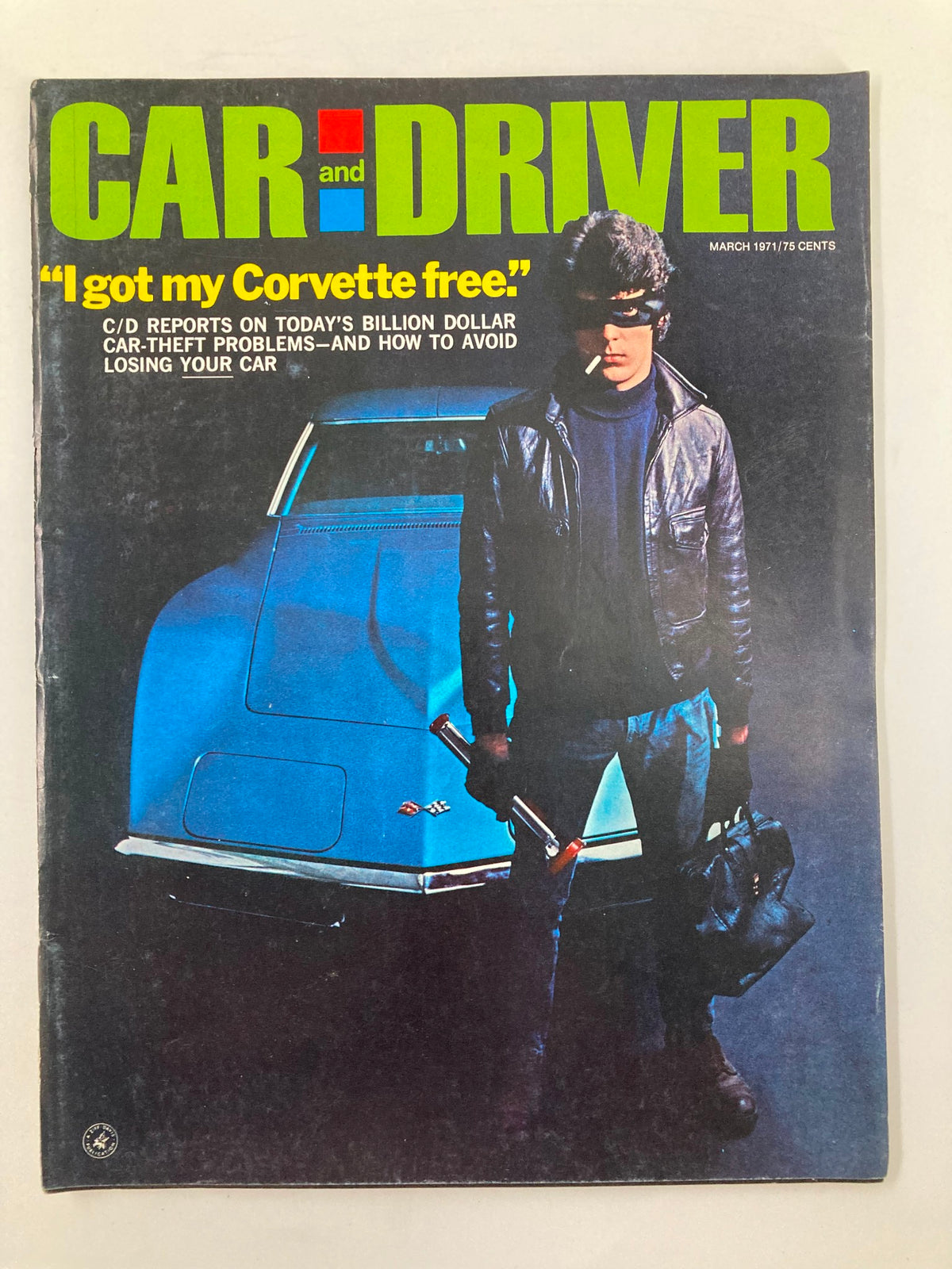 Cover of March 1971 Car and Driver Magazine featuring the title 'I got my Corvette free' with a figure holding a crowbar and wearing a leather jacket, standing in front of a blue Corvette.