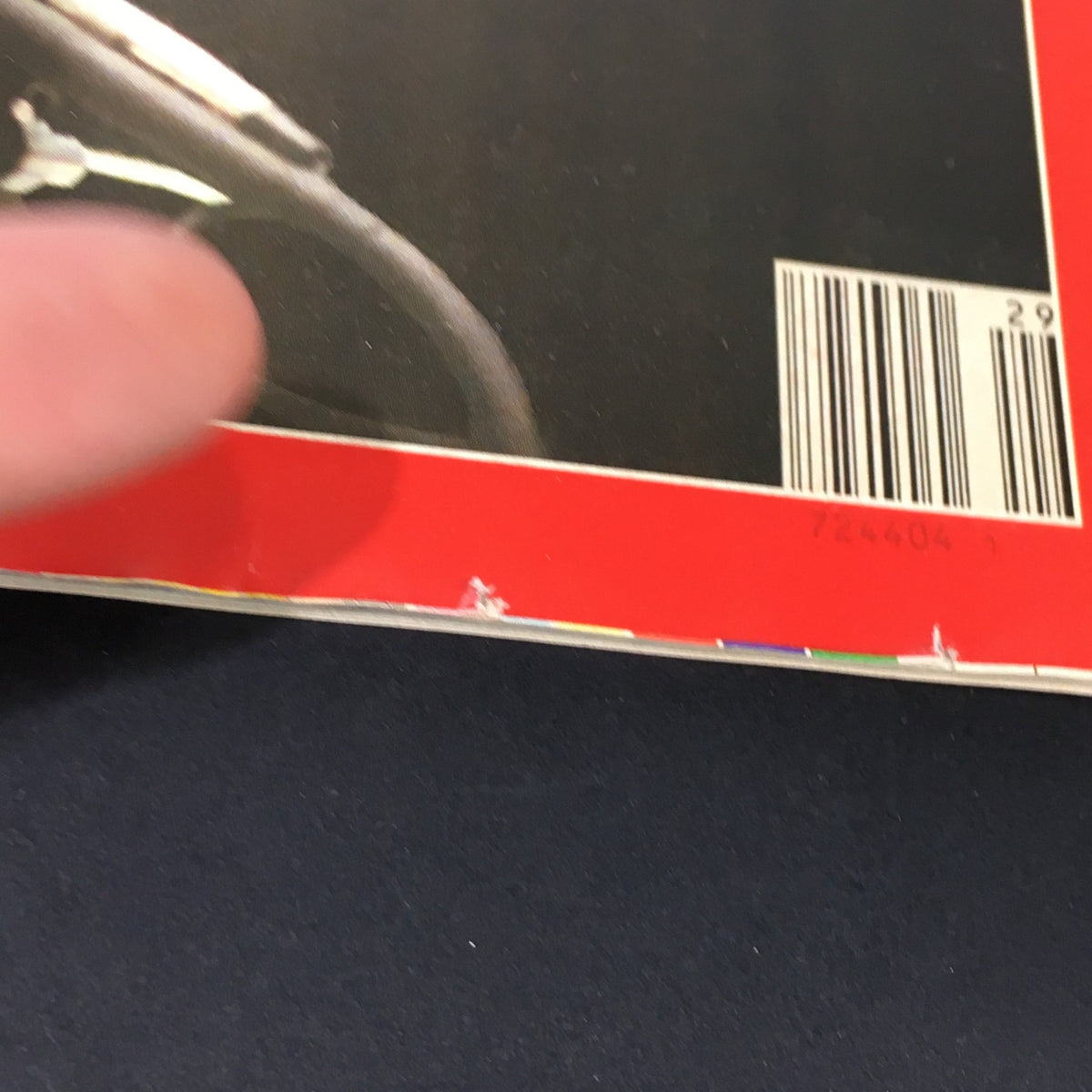 Close-up view of the edge of the vintage Time Magazine dated July 20, 1987, featuring Oliver North and stories on Close Calls in the Air, highlighting minor wear and a small tear.
