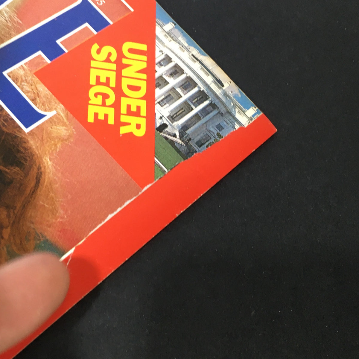 Close-up view of the corner of VTG Time Magazine March 2, 1987, showing the 'Under Siege' banner and minor wear indicating its vintage condition.