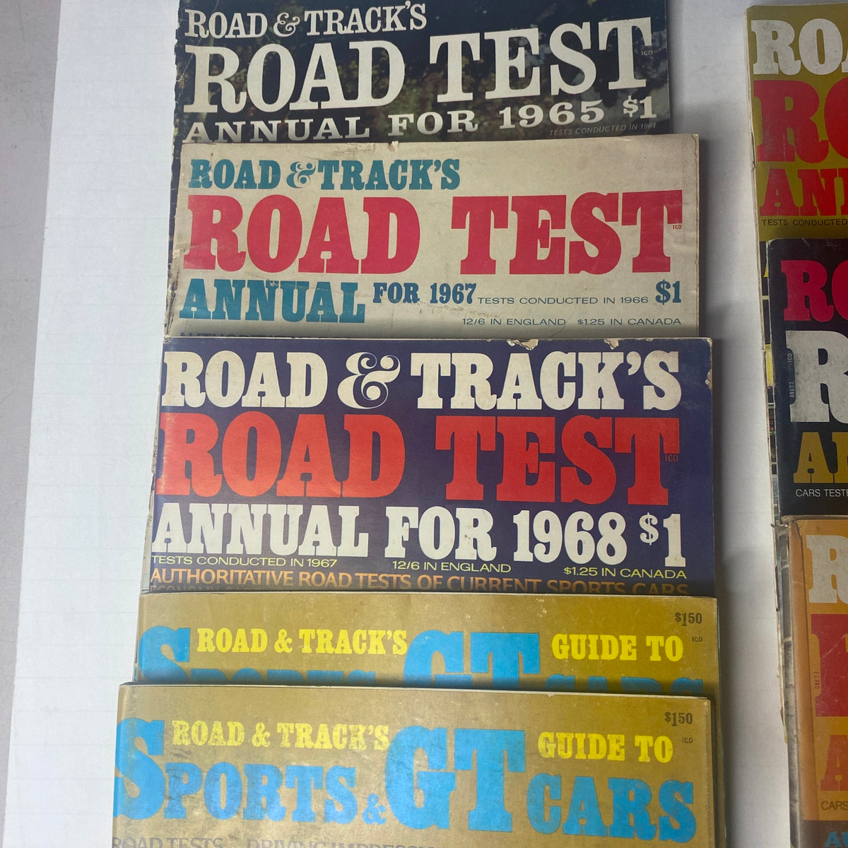 Various covers of Road & Track Road Test Annuals from 1965 to 1973, part of a lot of 8 magazines including Sports & GT Cars Guide.
