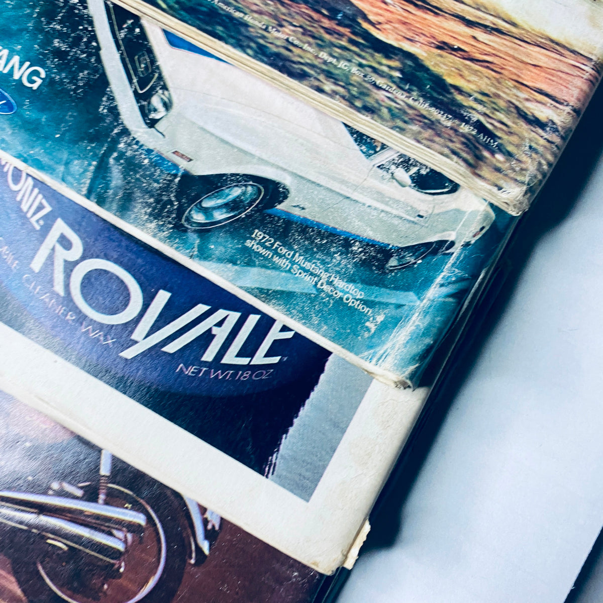 Lot of 11 Car and Driver Magazine 1972 January - September & December Set displaying a close-up of a Ford vehicle advertisement alongside a motorcycle brand logo.
