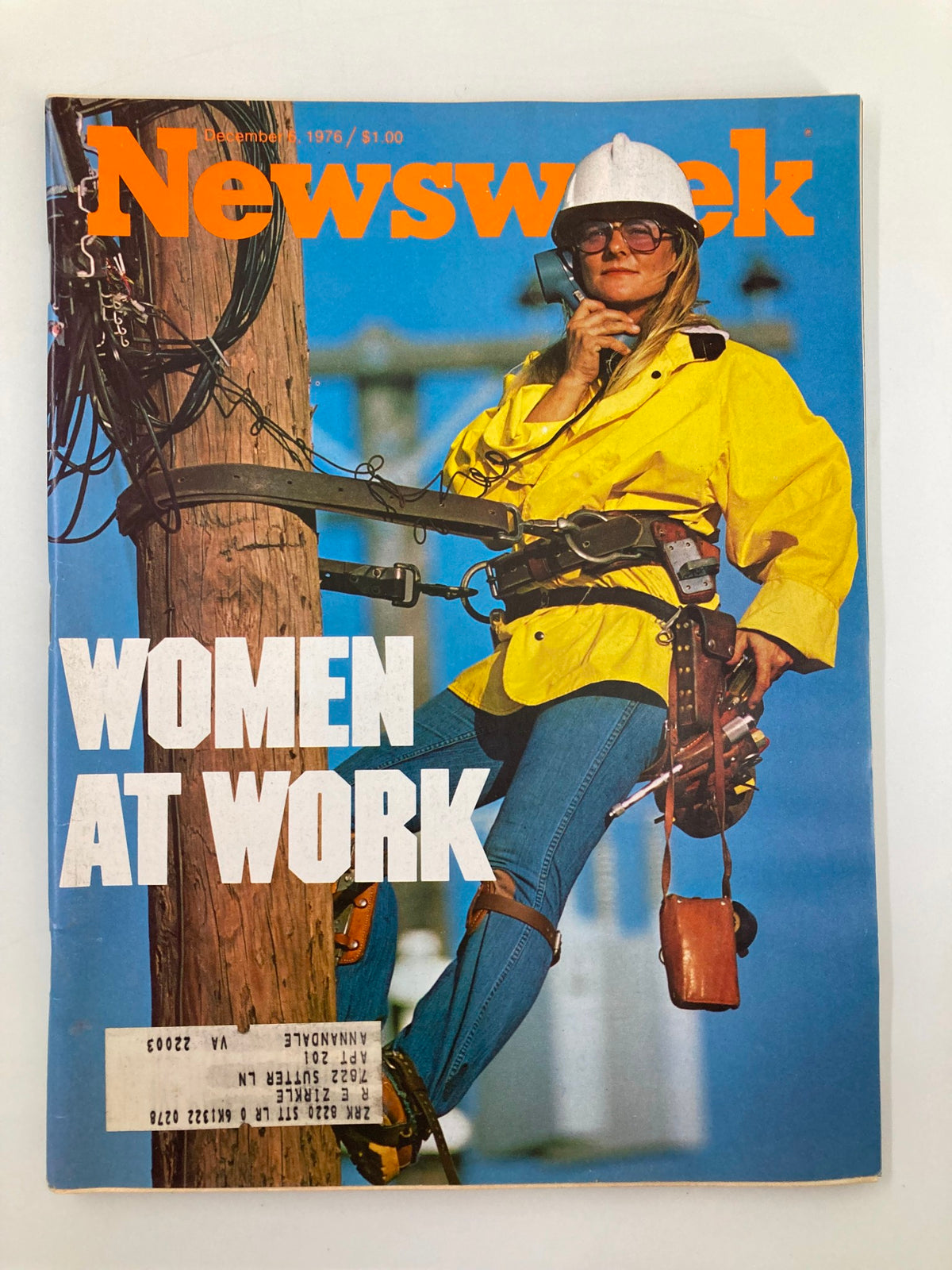 VTG Newsweek Magazine December 6 1976, cover featuring a photograph of a woman at work, wearing a yellow raincoat and hard hat while on telephone and climbing a utility pole, representing women's contributions to the workforce.