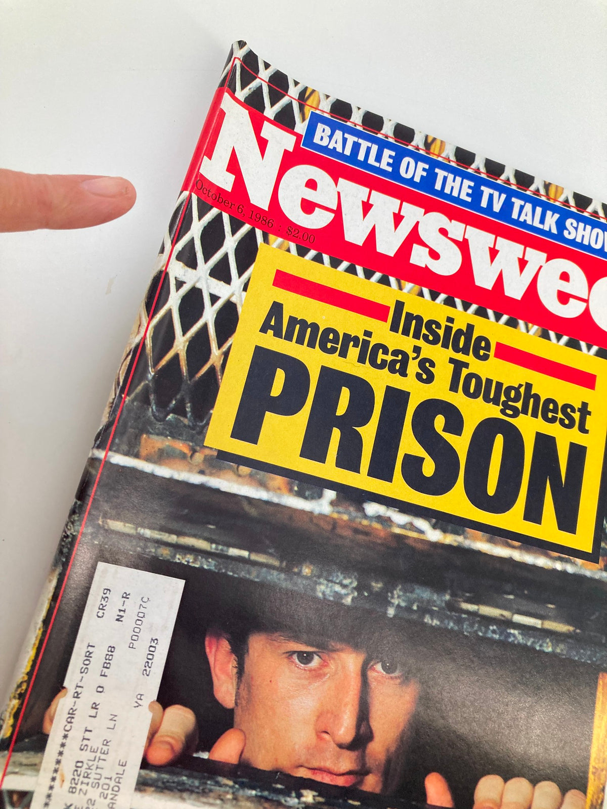 Close-up view of the vintage Newsweek magazine cover from October 6, 1986, showcasing 'Inside America's Toughest Prison' with text and prison imagery.