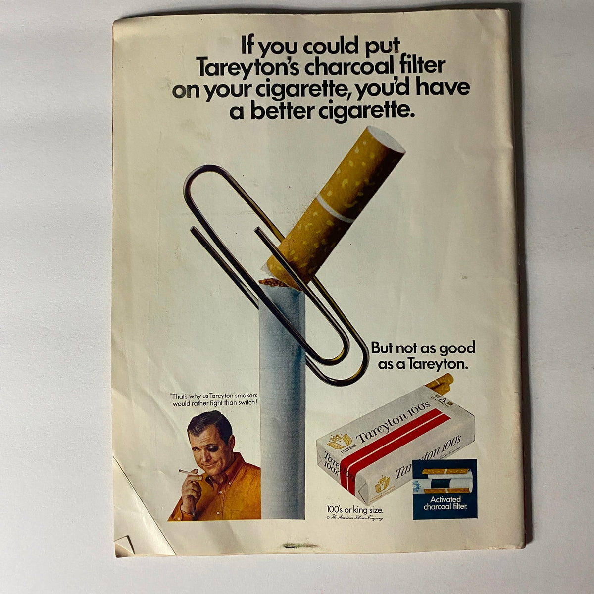 Advertisement for Tareyton Cigarettes from a vintage magazine, depicting a charcoal filter and emphasizing the slogan about having a better cigarette, set against a classic retro design.