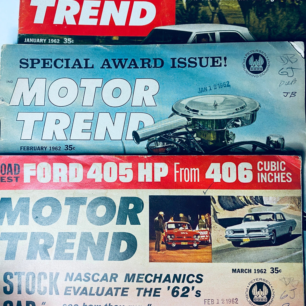 Three Motor Trend Magazine covers from early 1962, including January, February, and March issues featuring road tests and automotive insights.