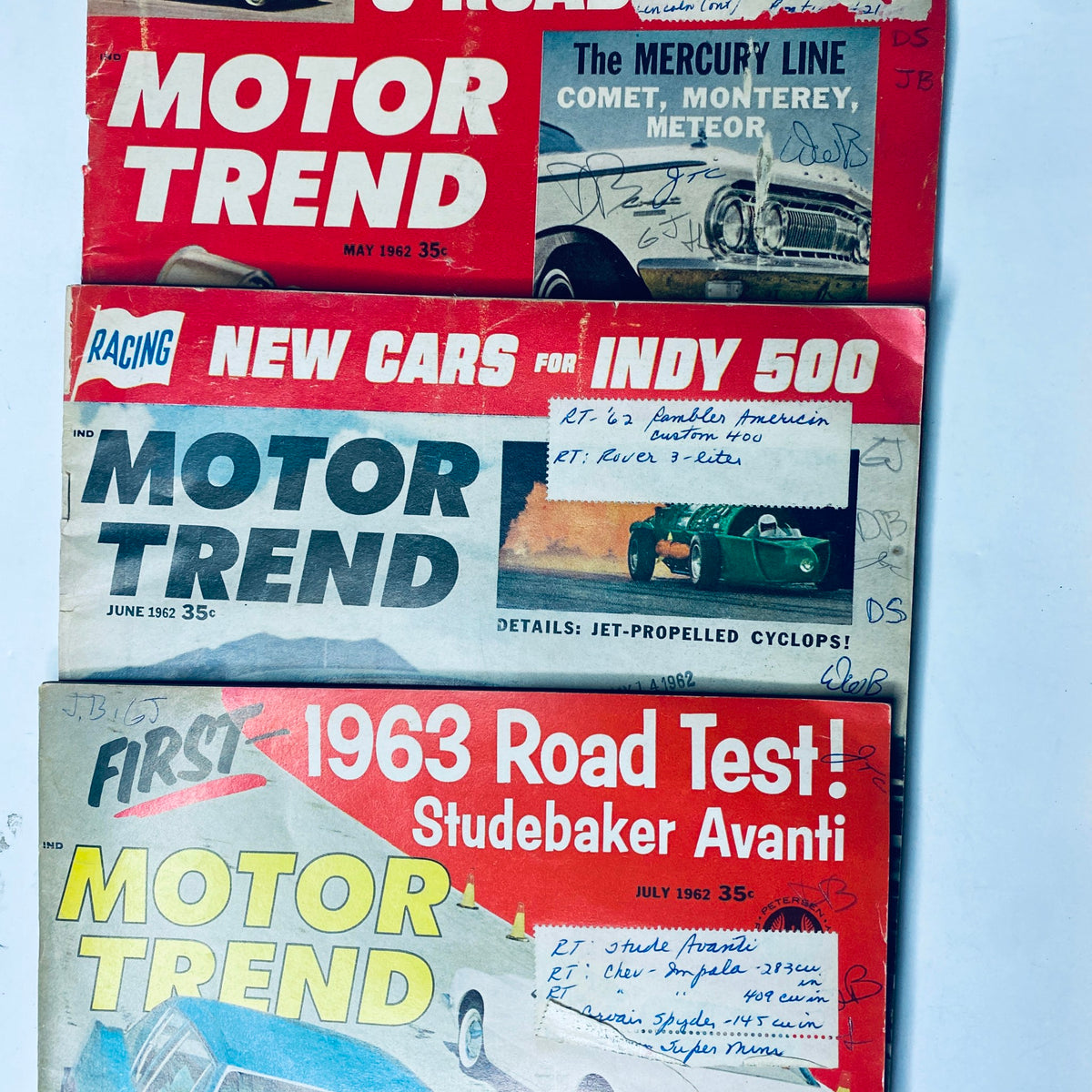 Lot of 11 Motor Trend Magazine covers from 1962, featuring the May issue with a vintage car and the 1963 Road Test Studebaker Avanti, along with race and auto reviews.