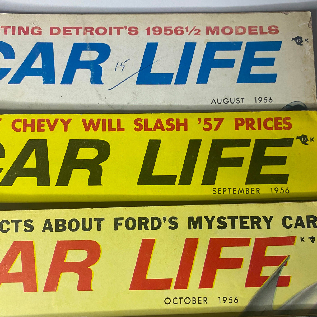 Covers of Car Life magazine from August, September, and October 1956 highlighting topics such as Detroit's 1956 1/2 models and Chevy's slashing prices for '57. Part of the lot of 10 Car Life The Family Auto Magazine 1956.