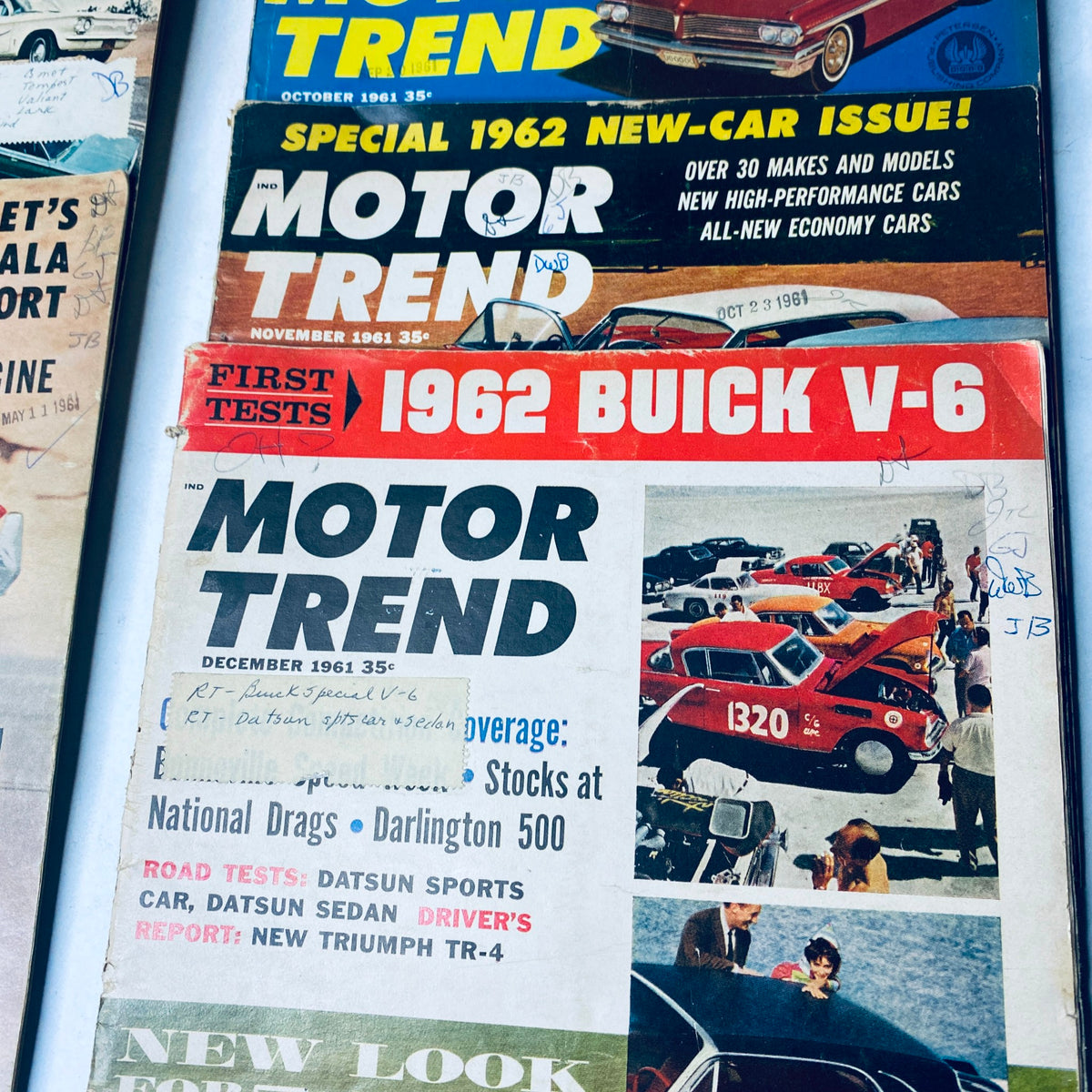 Lot of 12 Motor Trend Magazine covers from October 1961 to December 1961, presenting automotive news and performance evaluations.