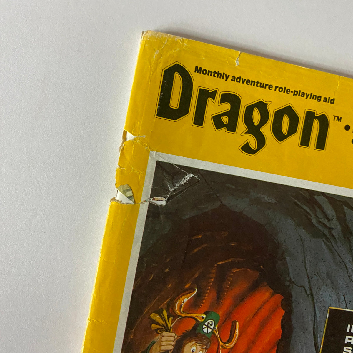 Close-up of the cover of VTG The Dragon Magazine April 1981 #48, emphasizing the worn edges and vintage details of the Internal Revenue Service theme.