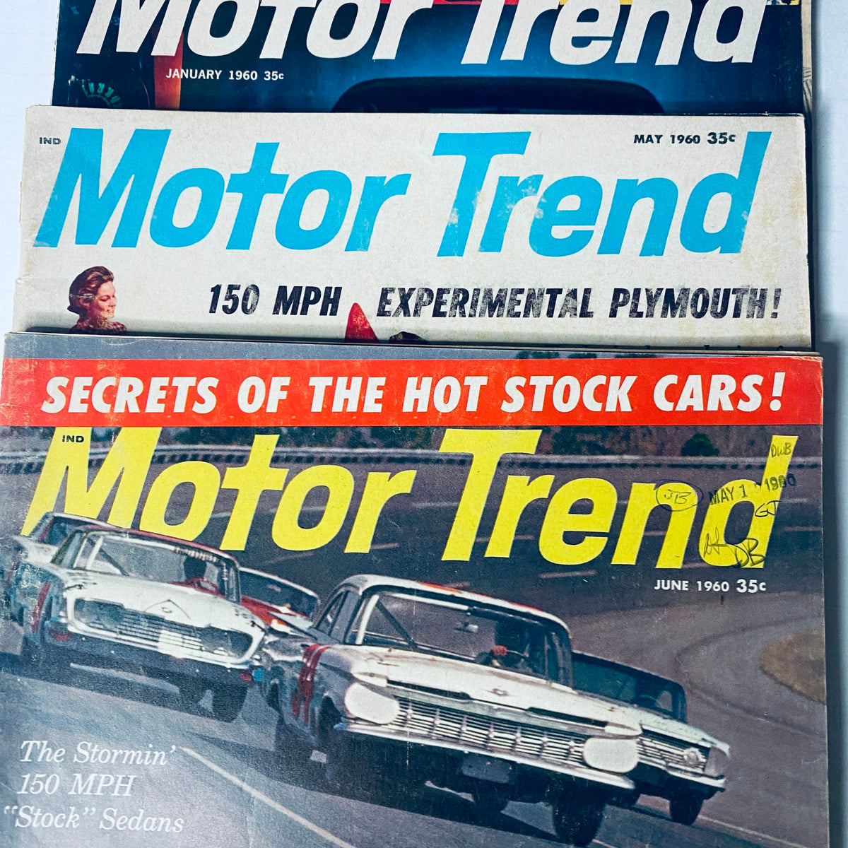 Vintage Motor Trend Magazine covers from January and May to June 1960 showcasing classic cars and automotive features.