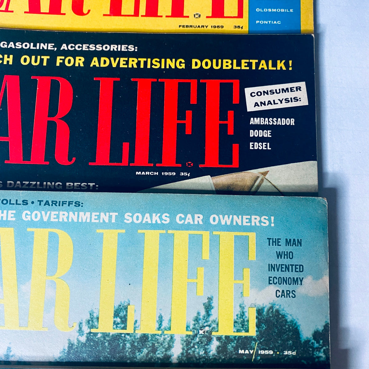 Lot of 8 Car Life Magazine cover featuring editions from February and March 1959, showcasing automotive insights and advertisements.