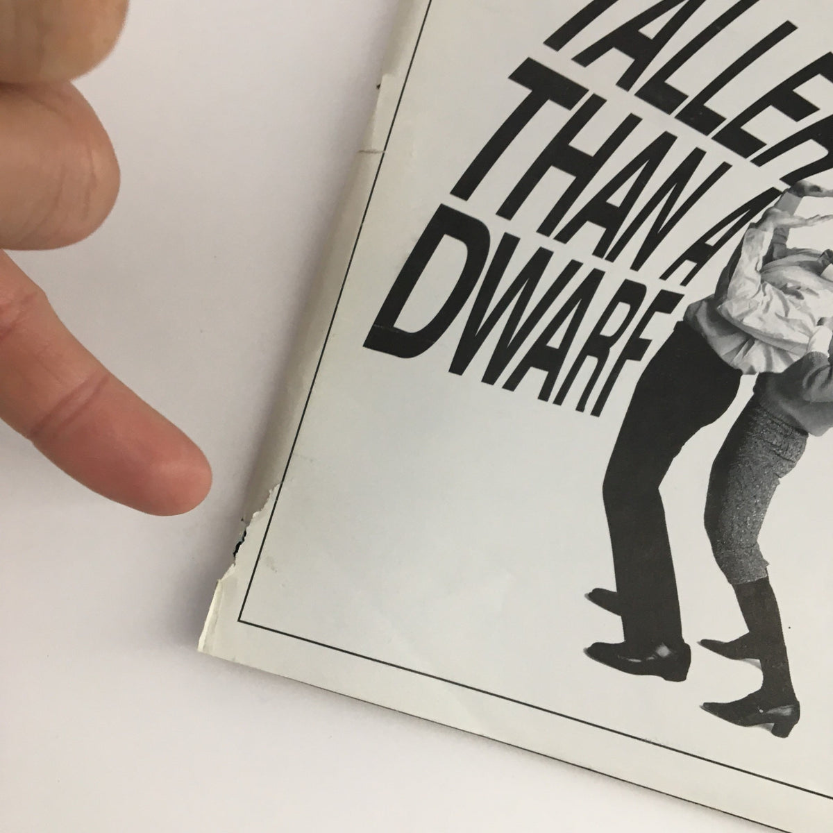 Close-up of the 2000 Playbill for Taller Than A Dwarf by Elaine May, showing minor wear and tear on the edge.
