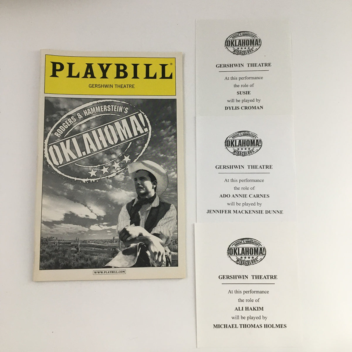 2003 Playbill for Rodgers & Hammerstein's Oklahoma! featuring a cover image of a cowboy and original paperwork details from the Gershwin Theatre.