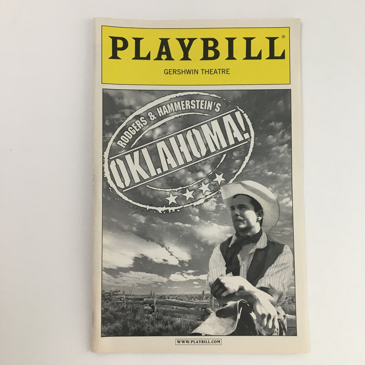 2003 Playbill for Rodgers & Hammerstein's Oklahoma! showcasing the iconic cover design with a cowboy graphic from the Gershwin Theatre.