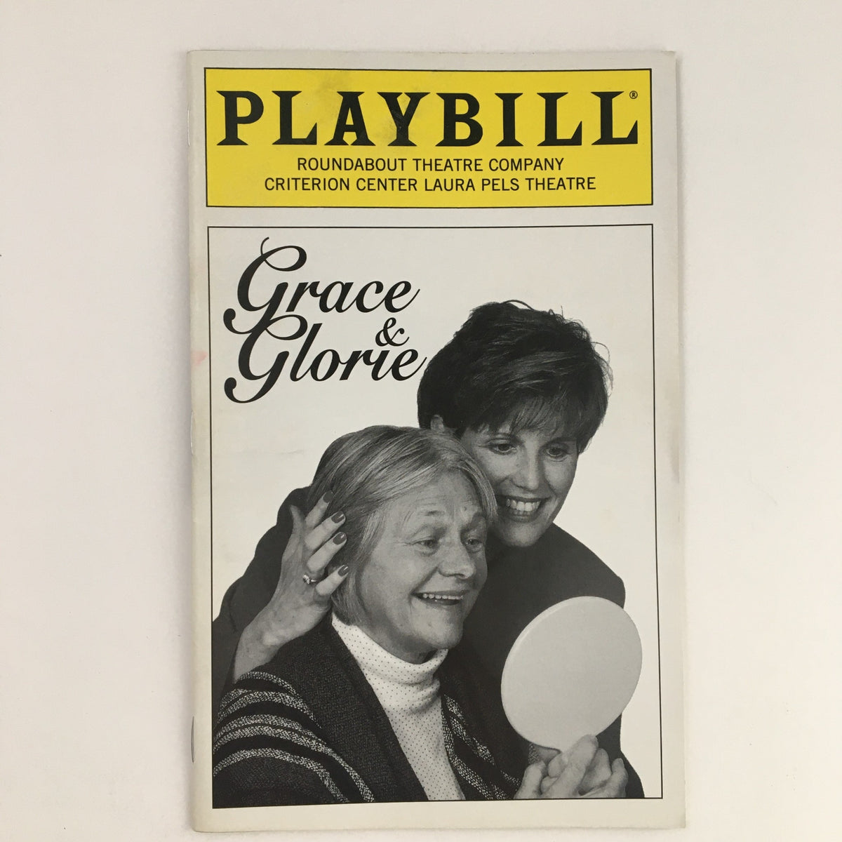 1996 Playbill Roundabout Theatre Company Presents Lucie Arnaz in Grace & Glorie, featuring a black and white image of two women, one holding a mirror, showcasing the play's intimate moment.