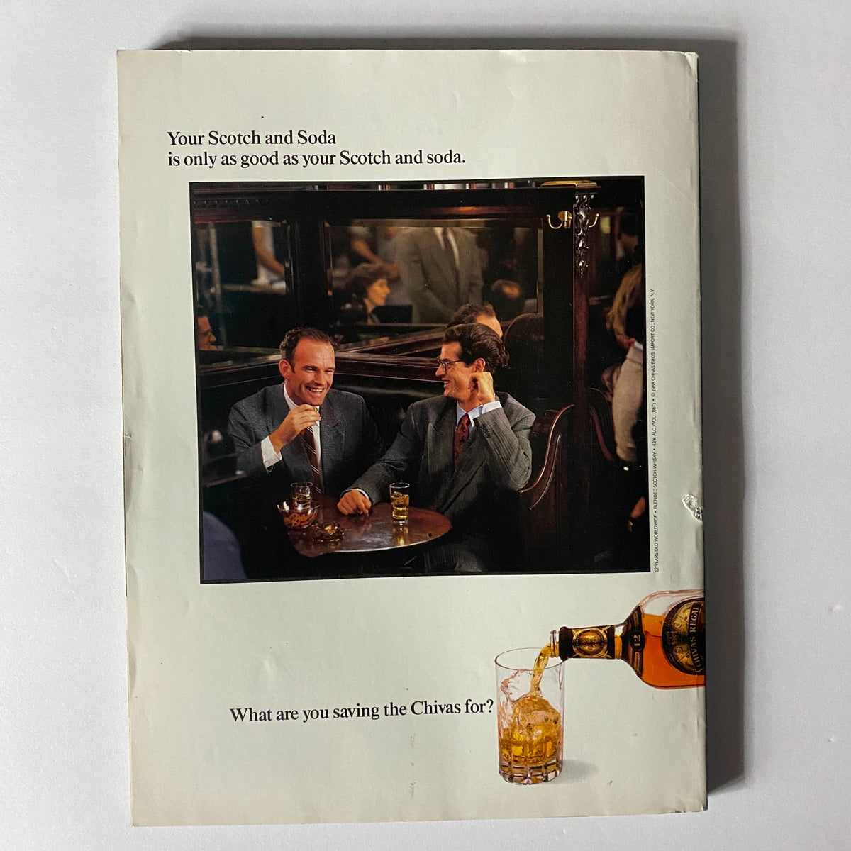 Back cover of the Sports Illustrated Magazine 1989 featuring an advertisement with two men enjoying drinks in a bar setting.