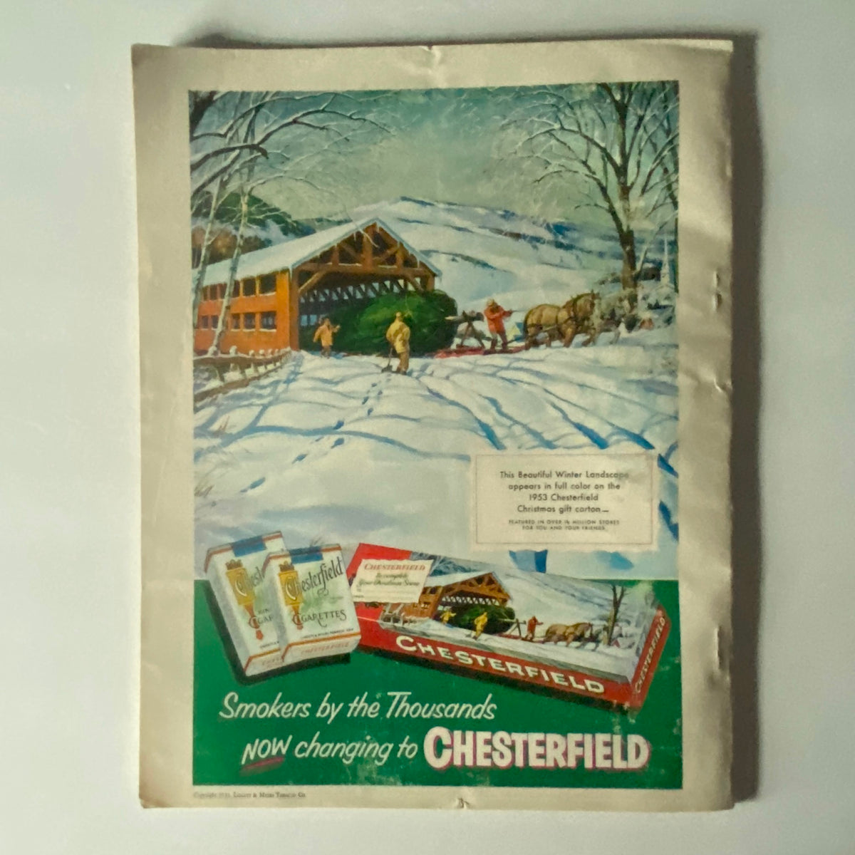 Back cover of VTG Photoplay Magazine December 1953 displaying a colorful Chesterfield cigarette advertisement featuring a winter landscape, illustrating vintage advertising aesthetics.