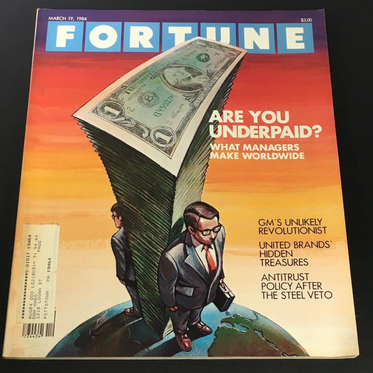 Fortune Magazine cover dated March 19, 1984, featuring the title 'Are You Underpaid?', with a prominent illustration of a towering stack of cash and a suited man standing on a globe. The issue includes the feature 'GM's Unlikely Revolutionist' among other articles, showcasing significant insights into management and economics from the 1980s.