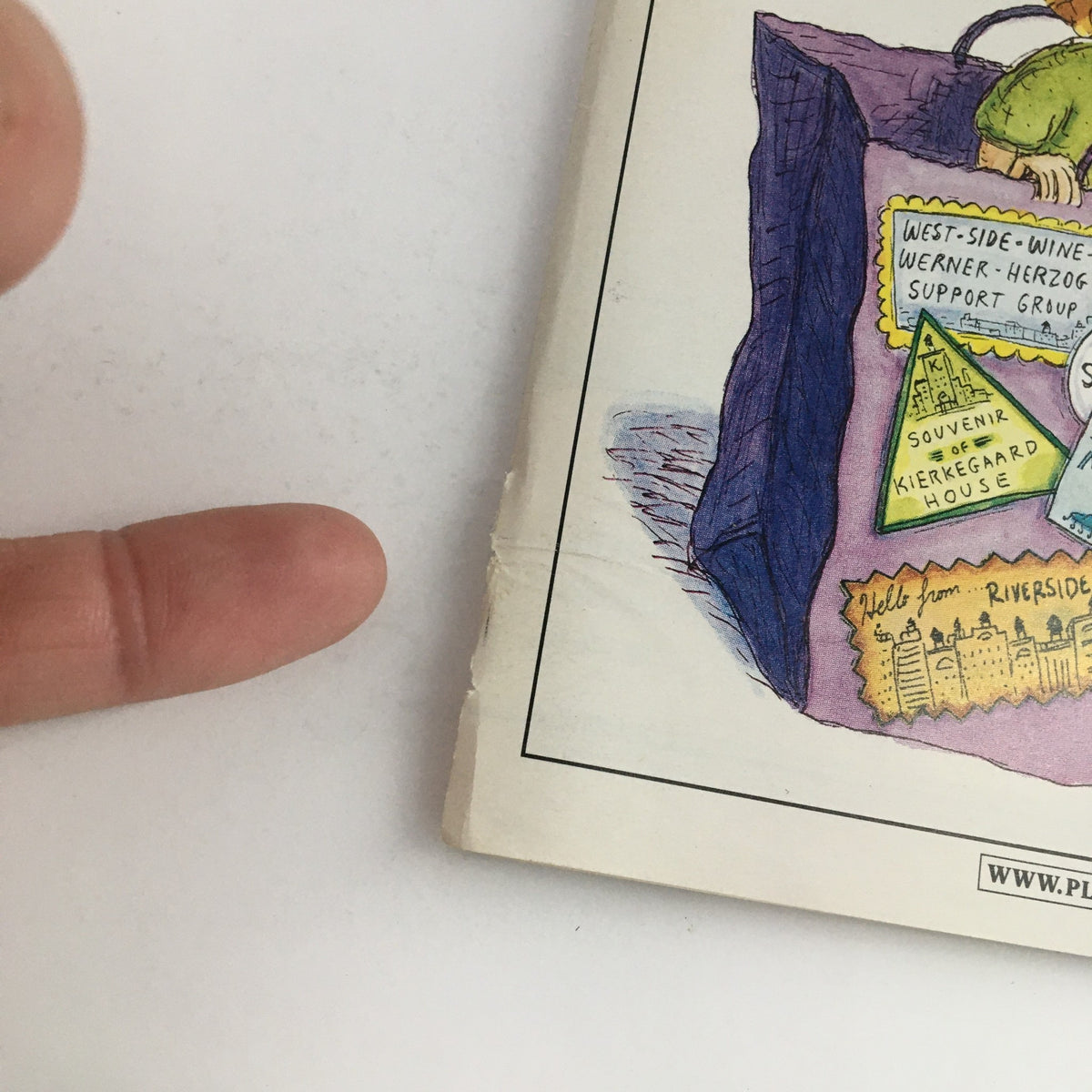 Close-up of the side of the 2000 Playbill for 'The Tale of The Allergist's Wife', showing detail of its binding and a hand pointing to a support group notice.