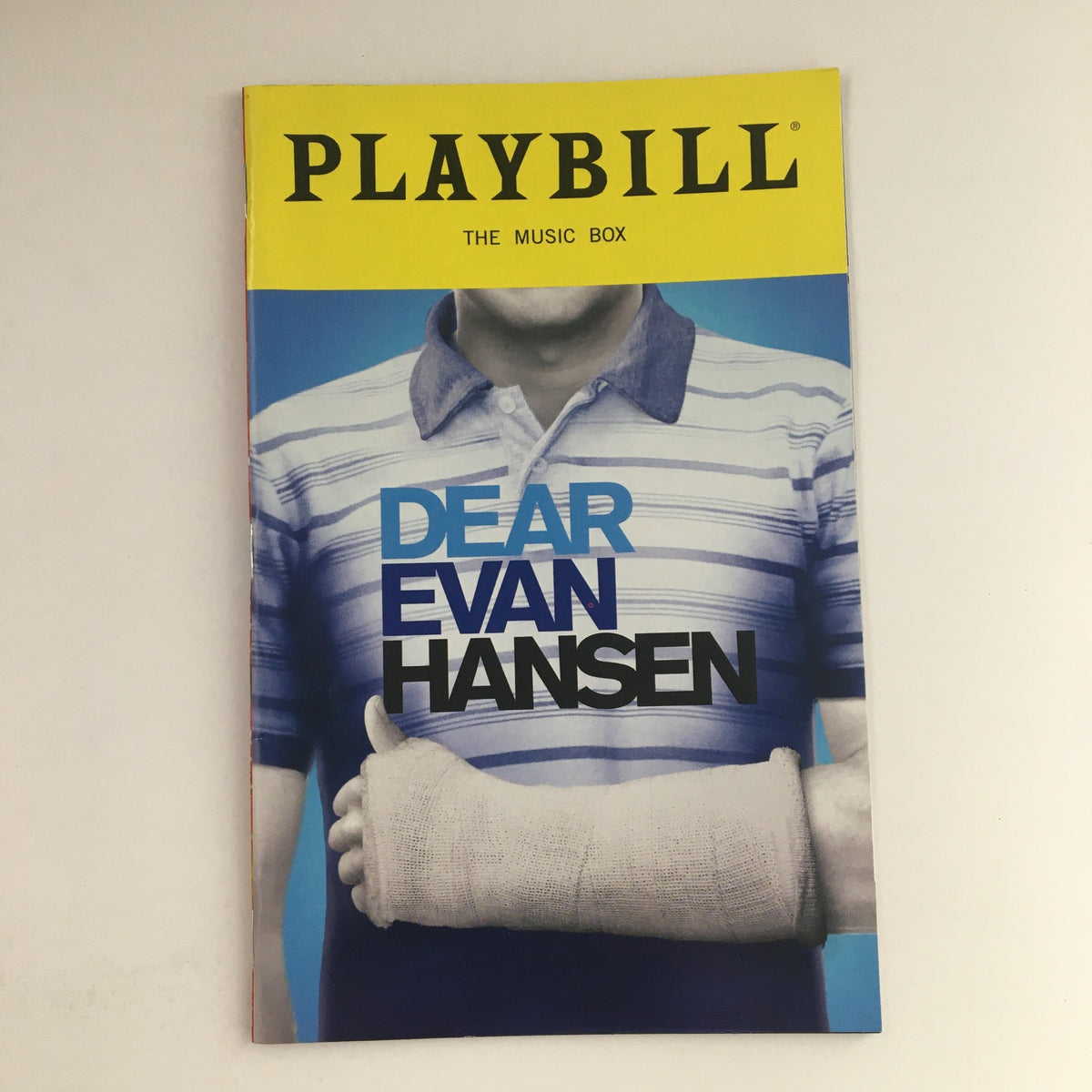 2015 Playbill for Dear Evan Hansen featuring a cover image with a character in a striped shirt and arm cast, presented at The Music Box Theatre.