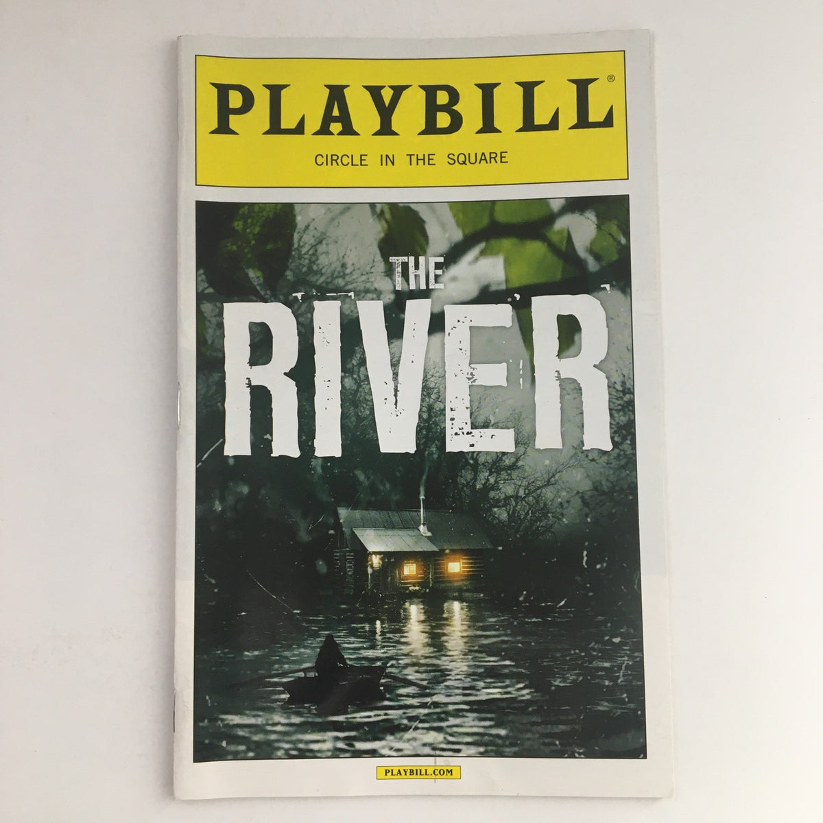 Cover of the 2014 Playbill for Circle In The Square presenting Hugh Jackman in The River, featuring a dark and moody design with a cabin in the water.