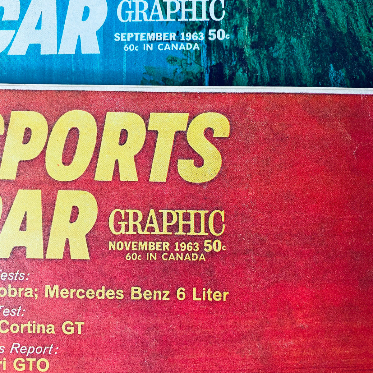 Detailed view of Sports Car Graphic magazine cover for November 1963, showcasing automotive articles and features. Lot of 9 Sports Car Graphic Magazine 1963 February - September, November.