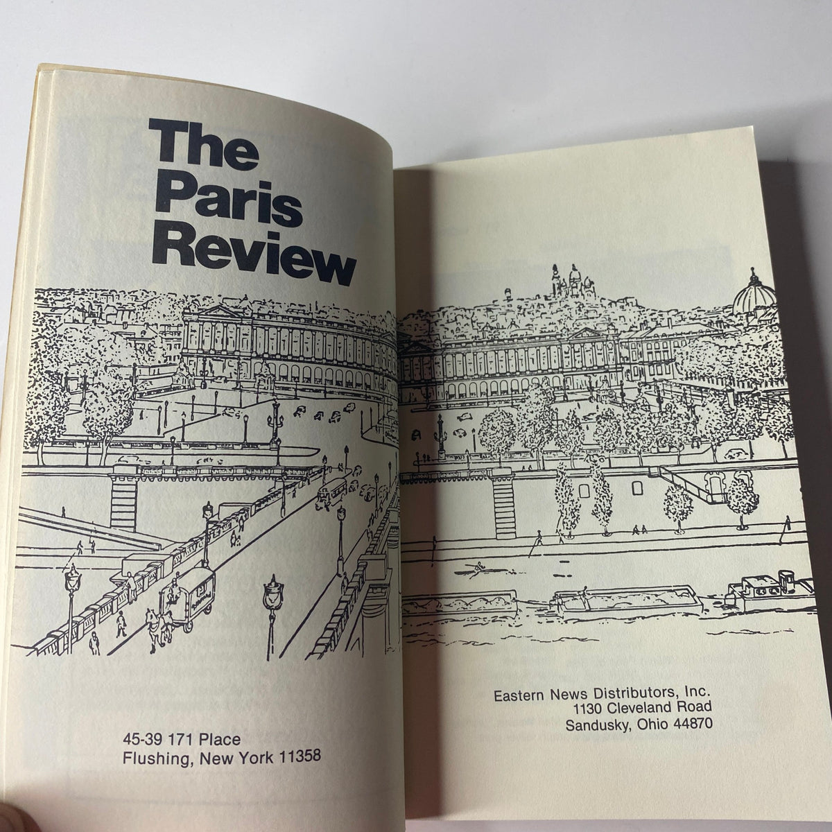 Inside view of The Paris Review Magazine Summer 1991 No. 119, displaying artwork and the title page featuring a drawing of a cityscape and publisher details.