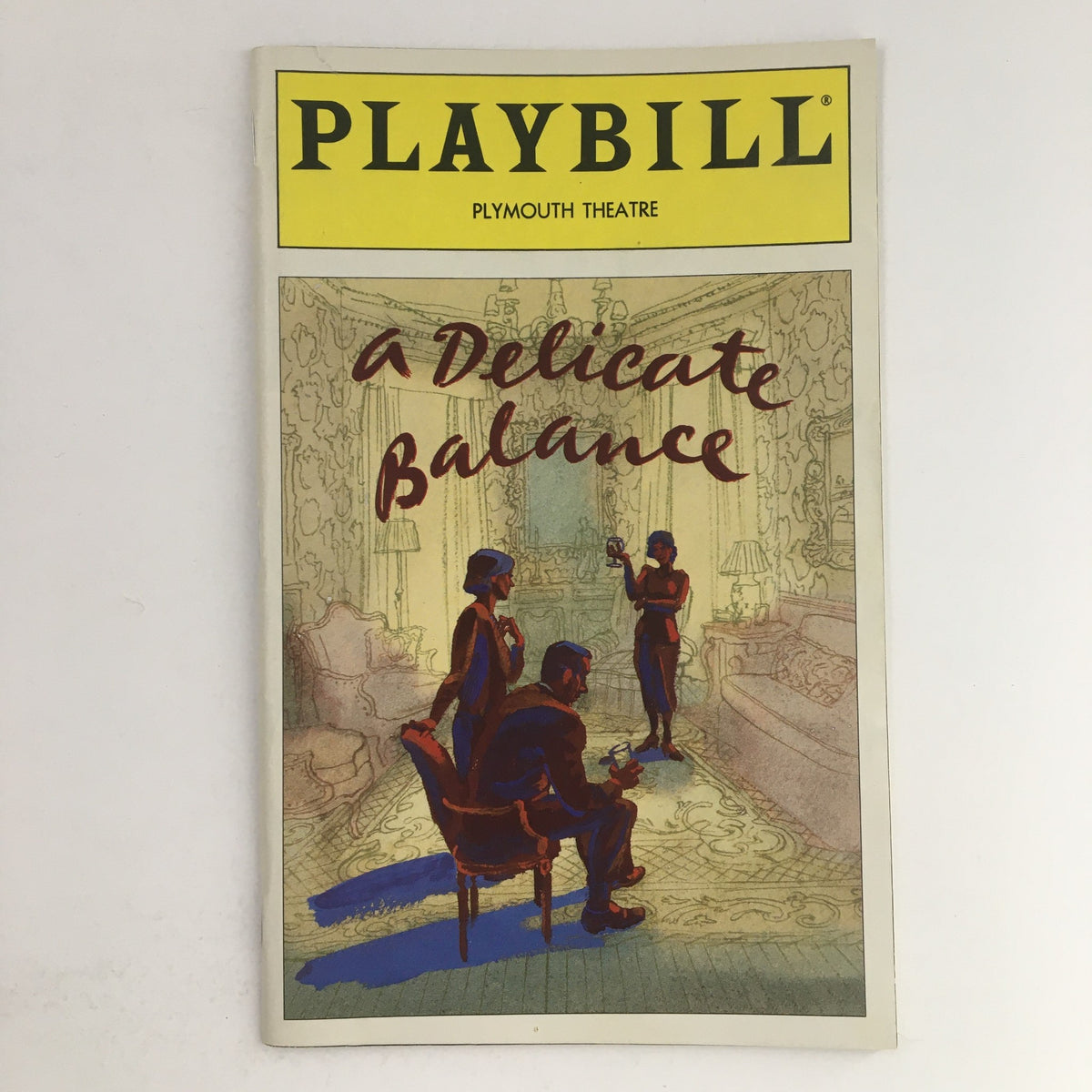 1996 Playbill for Edward Albee's A Delicate Balance featuring a colorful cover with an artistic depiction of characters in a living room setting at the Plymouth Theatre.