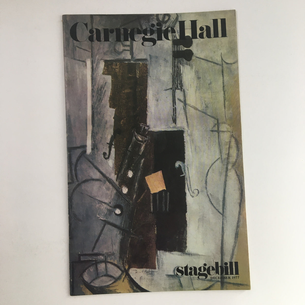 1977 Stagebill Carnegie Hall Present Sounds of Christmas by Herbert Kupferberg, featuring an artistic cover design with abstract elements and December 1977 date.