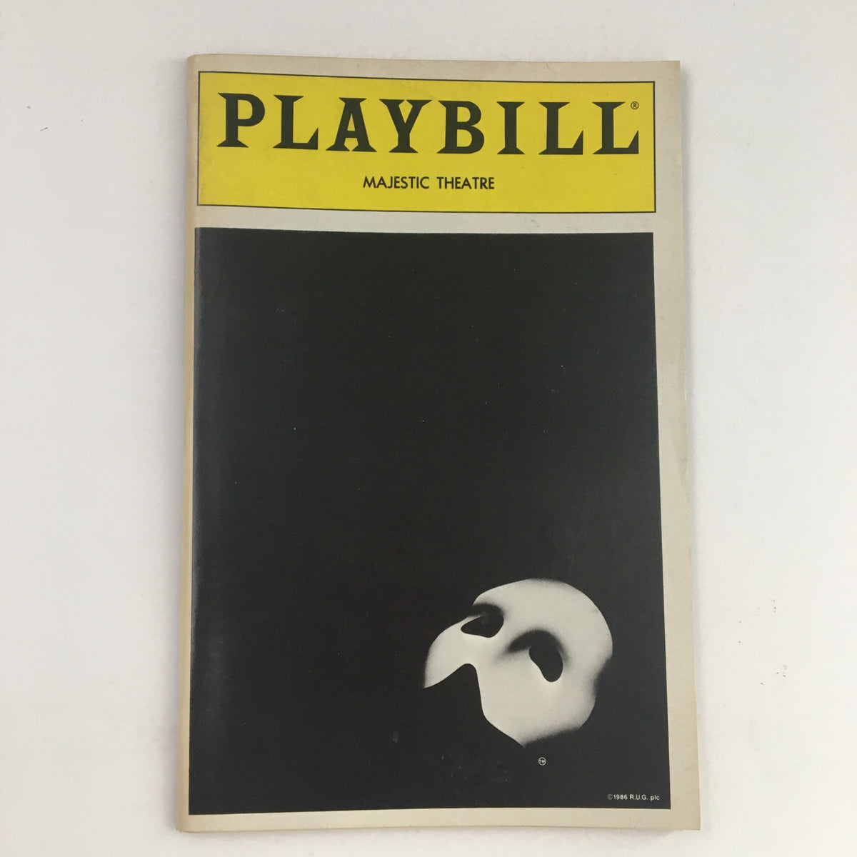 1988 Playbill Majestic Theatre presenting The Phantom of the Opera by Harold Prince, featuring a minimalistic cover design with a white mask on a black background.