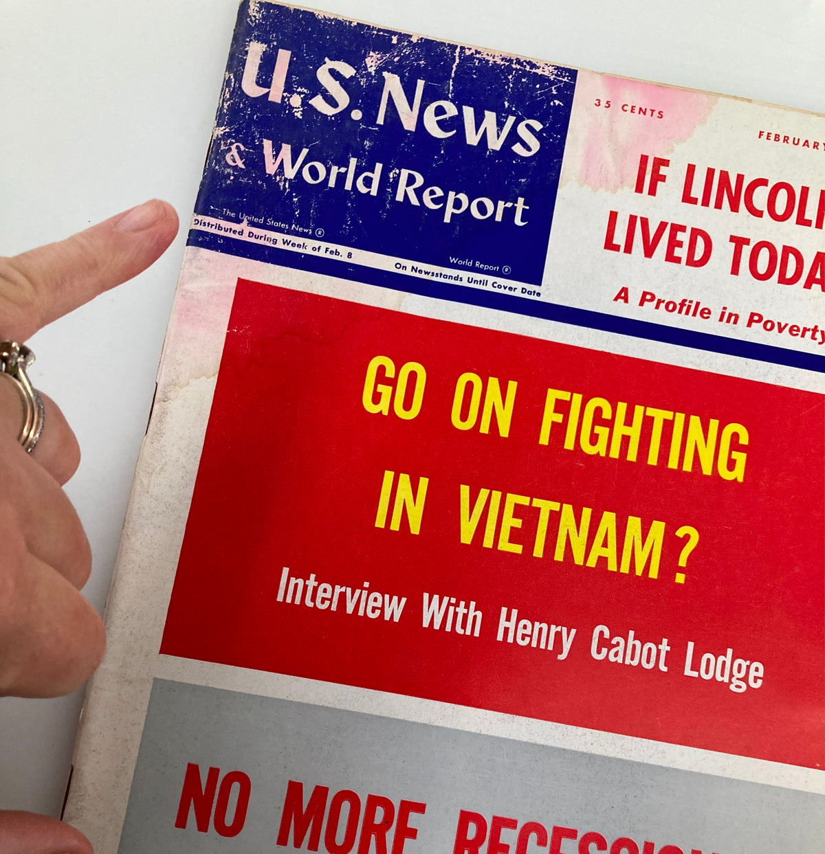 Close-up of the cover of US News & World Report Magazine February 15 1965 displaying the title 'Go On Fighting in Vietnam?' and other headlines including 'No More Recessions?'