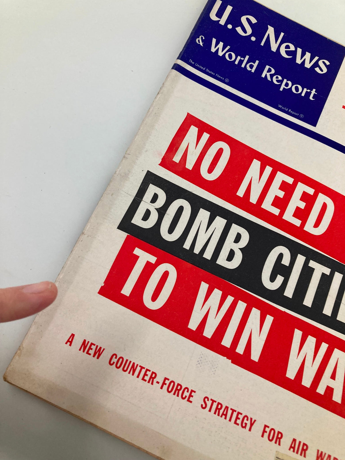 Close-up view of the US News & World Report Magazine cover from January 28, 1955, highlighting the provocative headline 'No Need to Bomb Cities to Win War' and the publication's branding. The image shows the magazine's vintage aesthetic and condition.