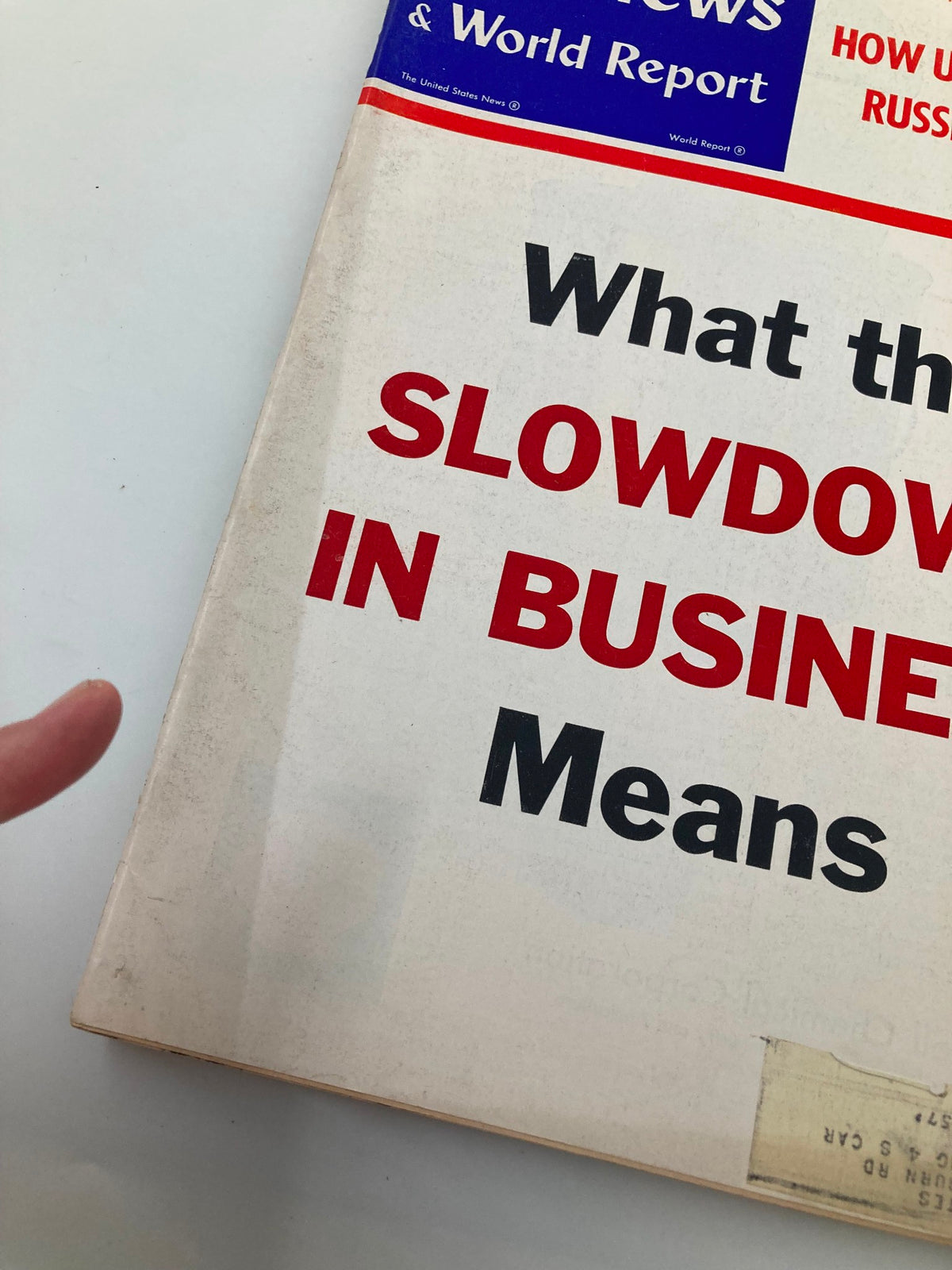 Close-up of the cover of US News & World Report Magazine September 13, 1957, highlighting the title 'What the Slowdown in Business Means' with visible wear and a label on the cover.