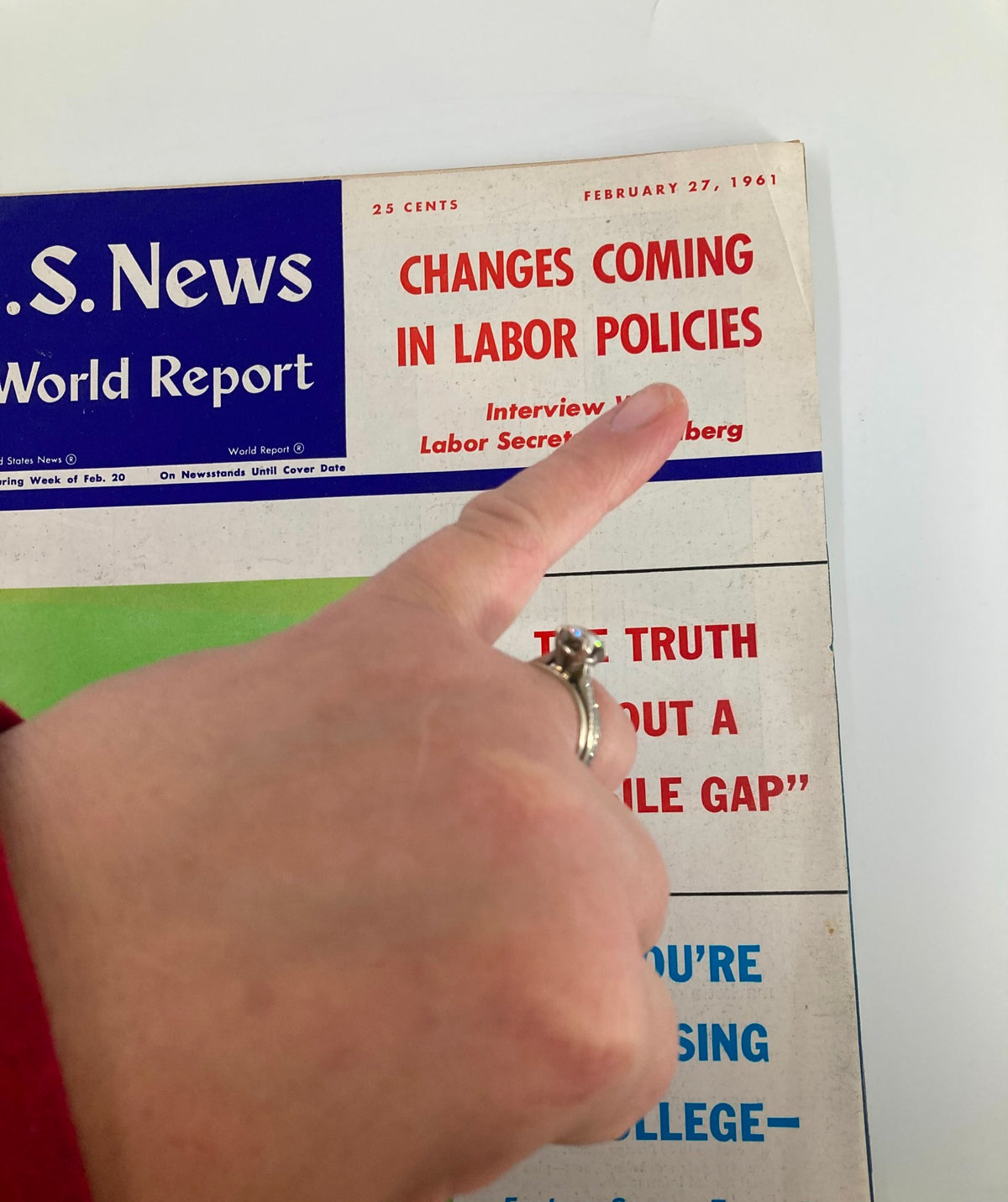 Close-up of US News & World Report Magazine February 27 1961 cover showing the title 'Changes Coming in Labor Policies' highlighted, with a hand pointing to the details.