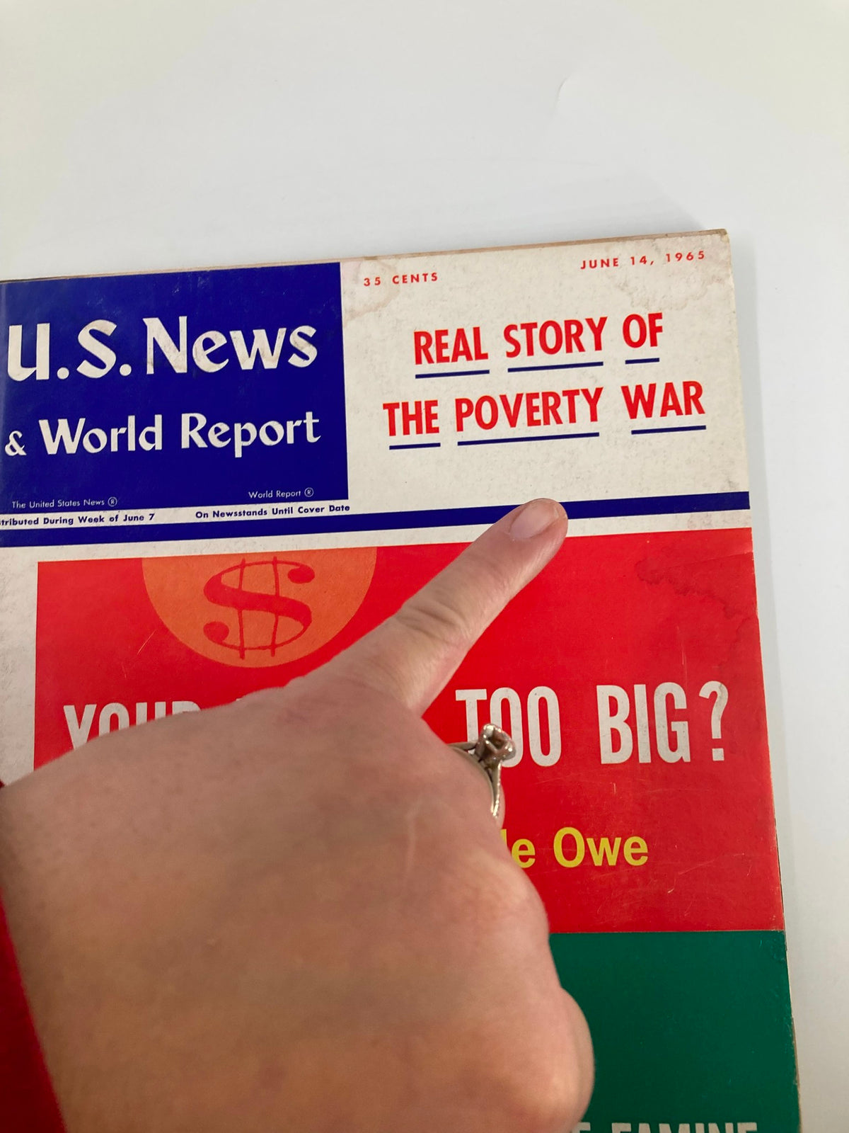 Cover of US News & World Report Magazine June 14, 1965 featuring the headline 'Real Story of The Poverty War' with a hand pointing to the text.