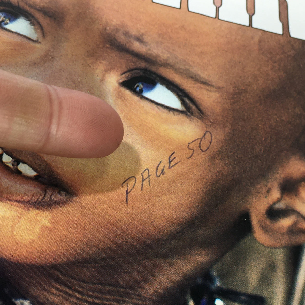 Close-up of the cover of VTG Newsweek Magazine November 26, 1984, showing a child with a handwritten note 'PAGE 50' on their face, emphasizing the magazine's theme 'Africa Nightmare / World Reaches Out.'