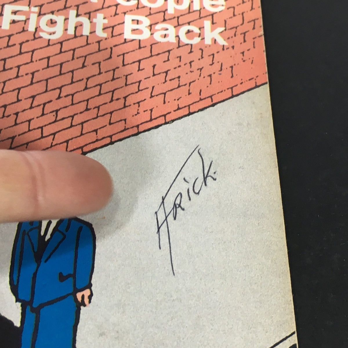 Close-up of the signature on the cover of VTG US News & World Report April 15, 1985, highlighting the signature of the illustrator, Frick, next to the title 'Street Crime, People Fight Back.'