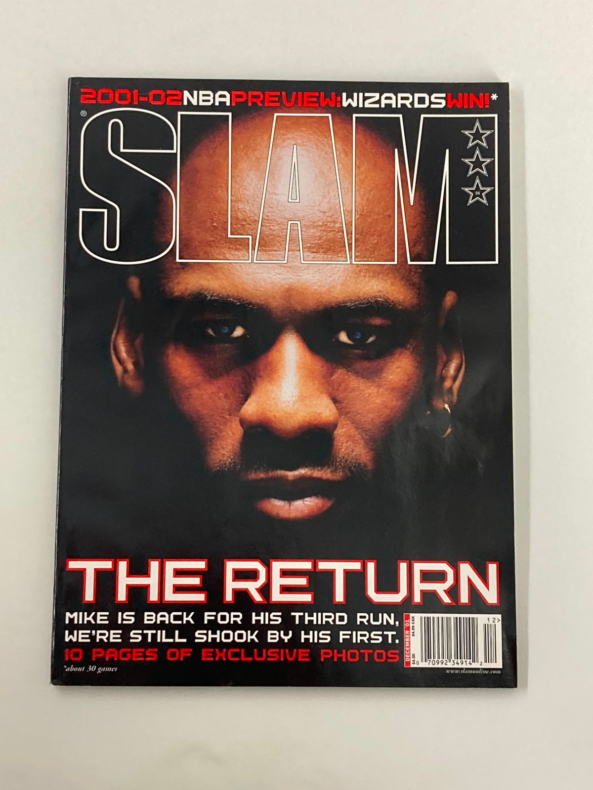 Slam Magazine December 2001 #56 featuring Michael Jordan on the cover with the title 'THE RETURN'. Highlights his comeback to the NBA after retirement.