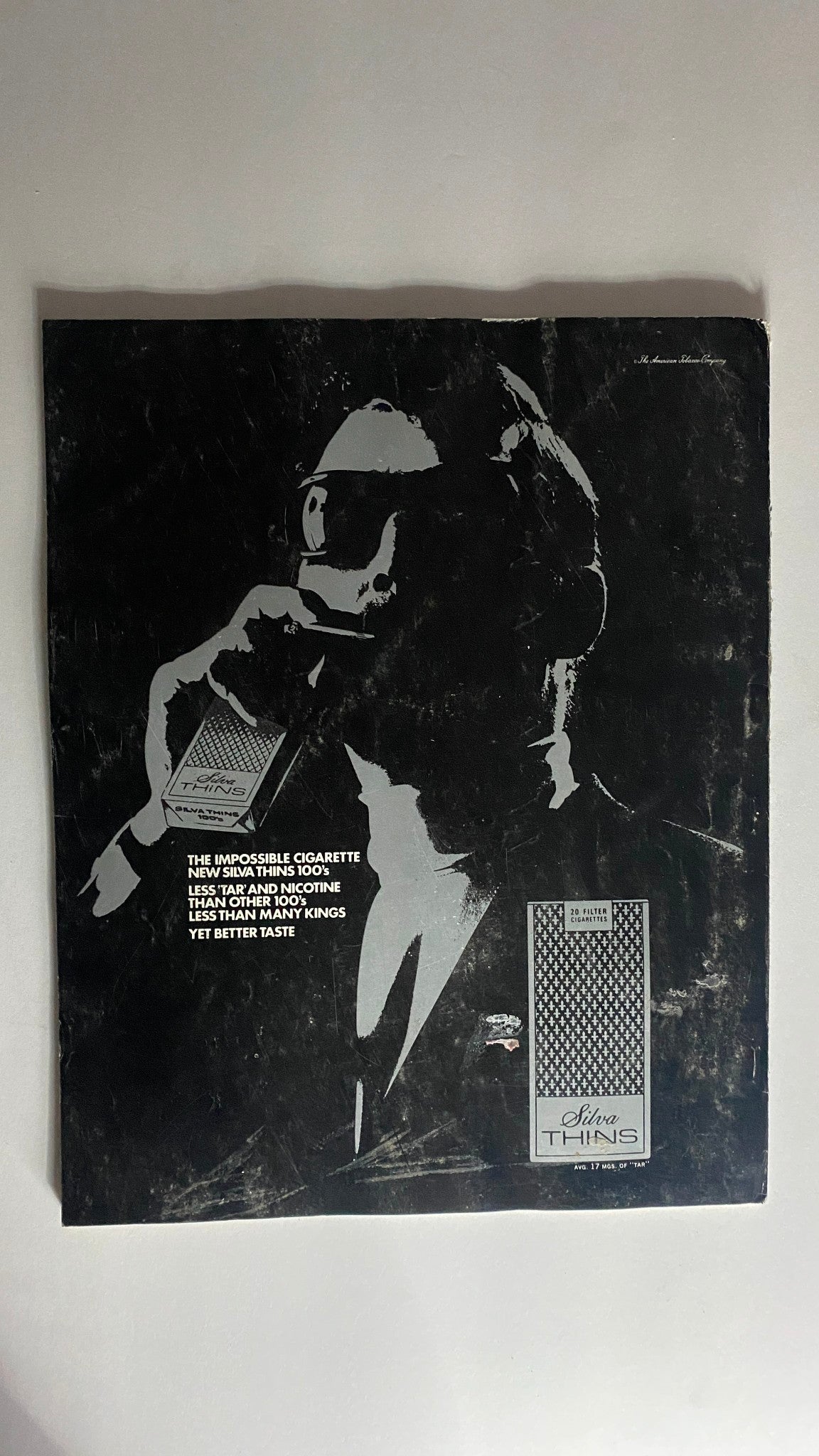 Cover of the VTG Holiday Magazine from June 1968 featuring an advertisement for Silva Thins cigarettes, showcasing a vintage design with a man in sunglasses, promoting the product's less tar and nicotine. Capture the essence of nostalgia in vintage magazine culture.