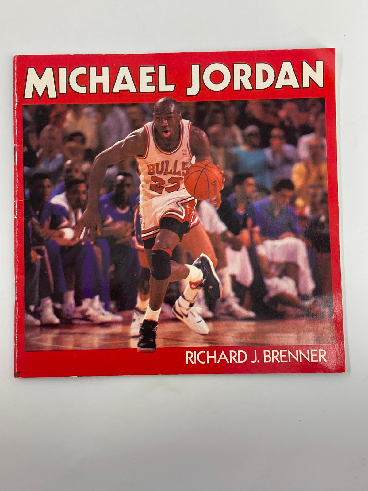 Cover of 'Illustrated Biography of Superstar Michael Jordan' by Richard J. Brenner featuring Michael Jordan in a Bulls uniform dribbling a basketball during a game.