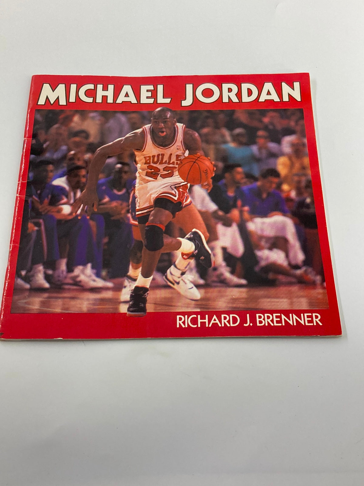 Alternate view of the cover of 'Illustrated Biography of Superstar Michael Jordan' by Richard J. Brenner showing Michael Jordan making a dynamic move with a basketball.
