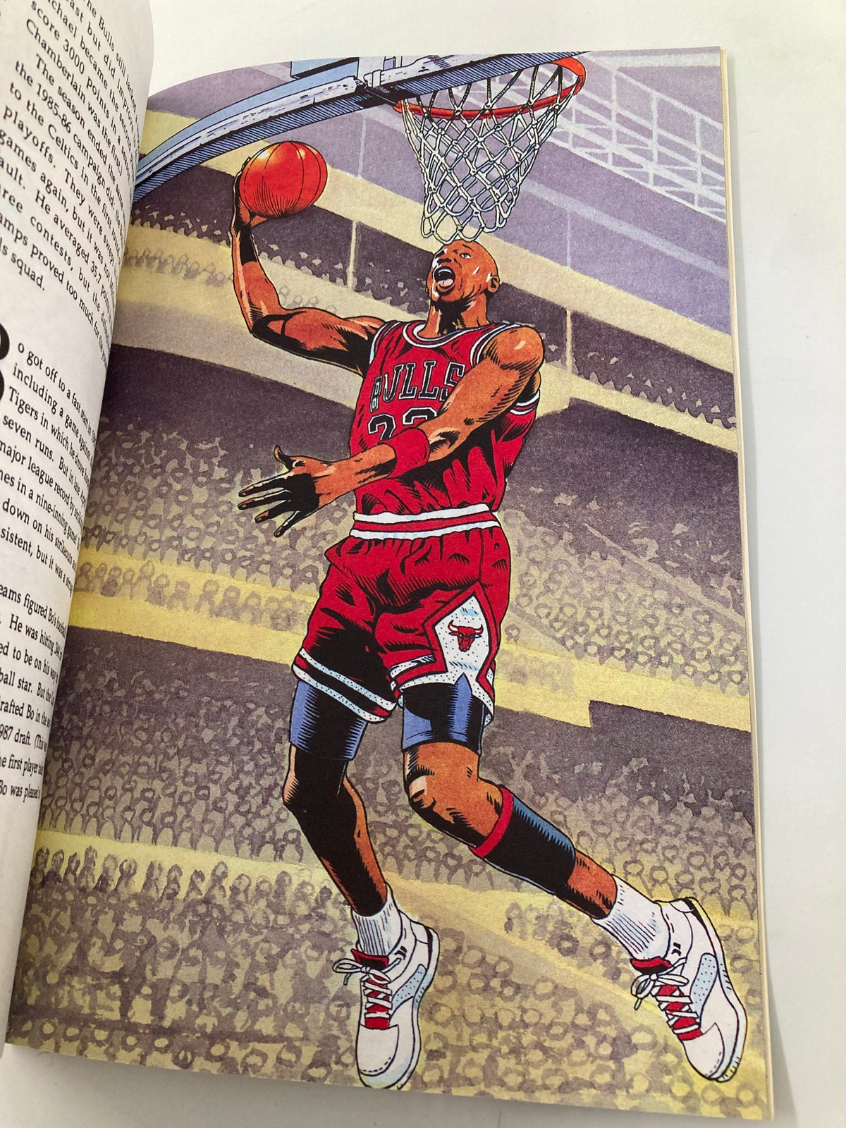 Illustration featuring Michael Jordan in a Chicago Bulls jersey, performing a slam dunk during a game, from the January 1992 Bo Jackson versus Michael Jordan #1 Illustration Biography VG.