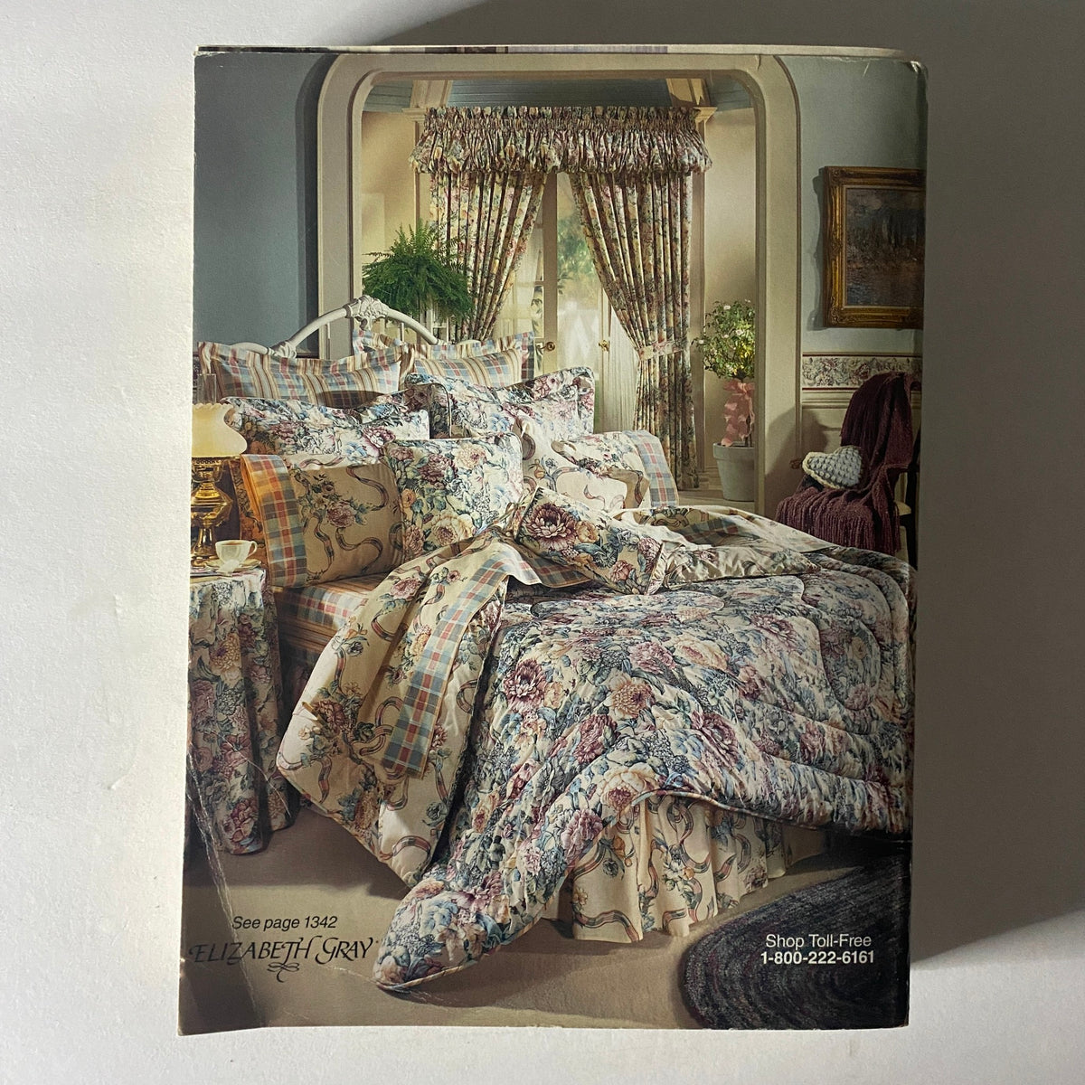 1994 JCPenney Spring and Summer Catalog featuring a beautifully styled bedroom with floral bedding and curtains, emphasizing textile designs and home décor.