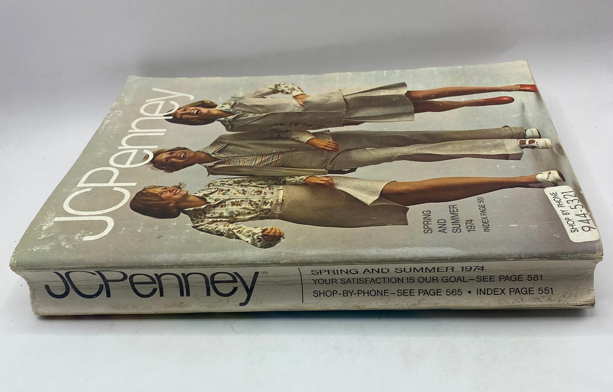 Spine view of the 1974 JCPenney Spring and Summer Catalog, showcasing its vintage style and wear, highlighting the year and shopping details.