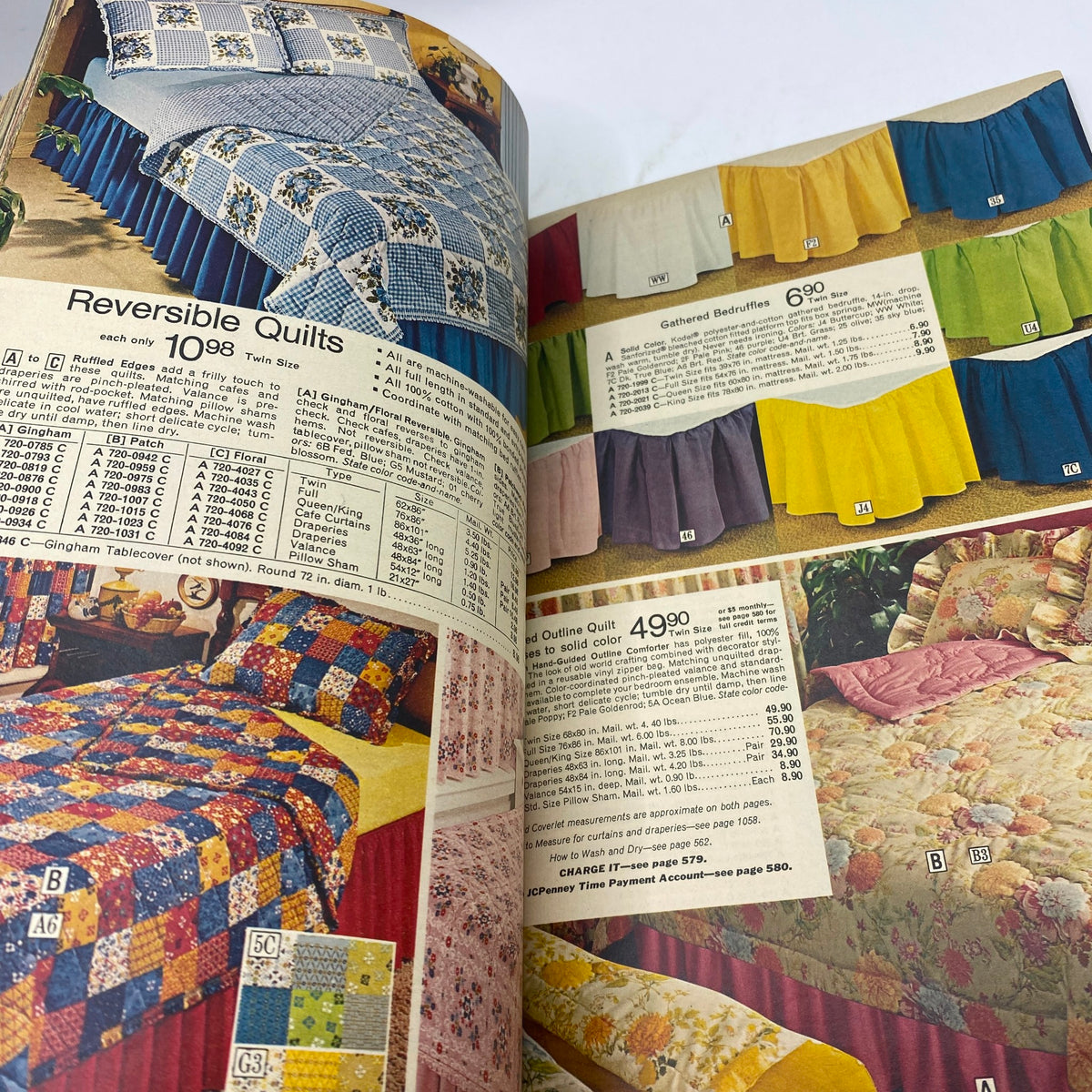 1974 JCPenney Spring and Summer Catalog featuring reversible quilts and gathered bedskirts in a variety of colors and patterns.
