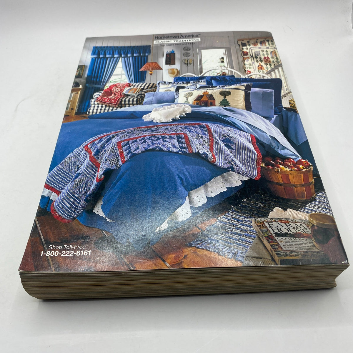 1994 JCPenney Fall and Winter Intarsia Sweater Catalog highlighting a cozy bedroom scene with blue-themed bedding and rustic decor elements.